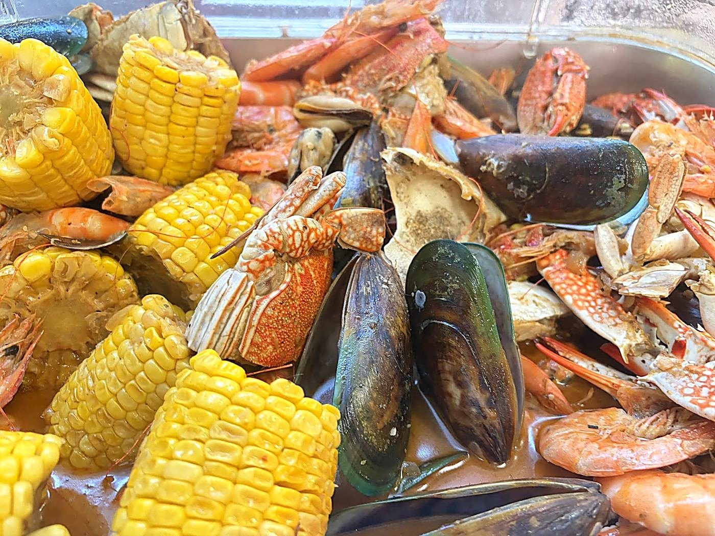 Spicy seafood boil with crab, prawns, and mussels